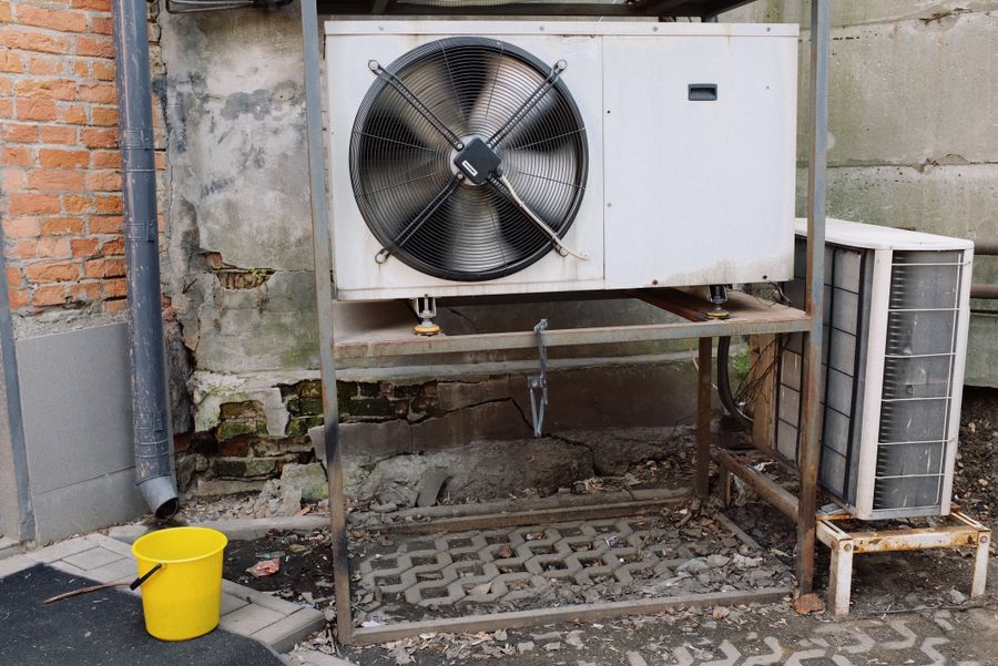 Outdoor AC condenser unit installed beside a home